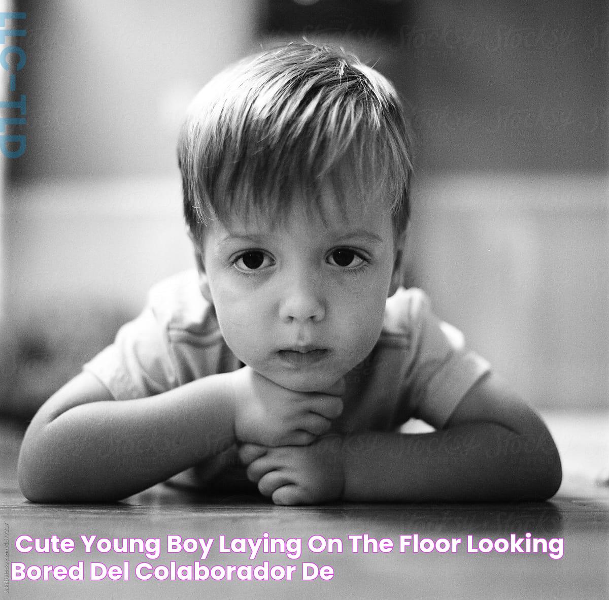 «Cute Young Boy Laying On The Floor Looking Bored» del colaborador de