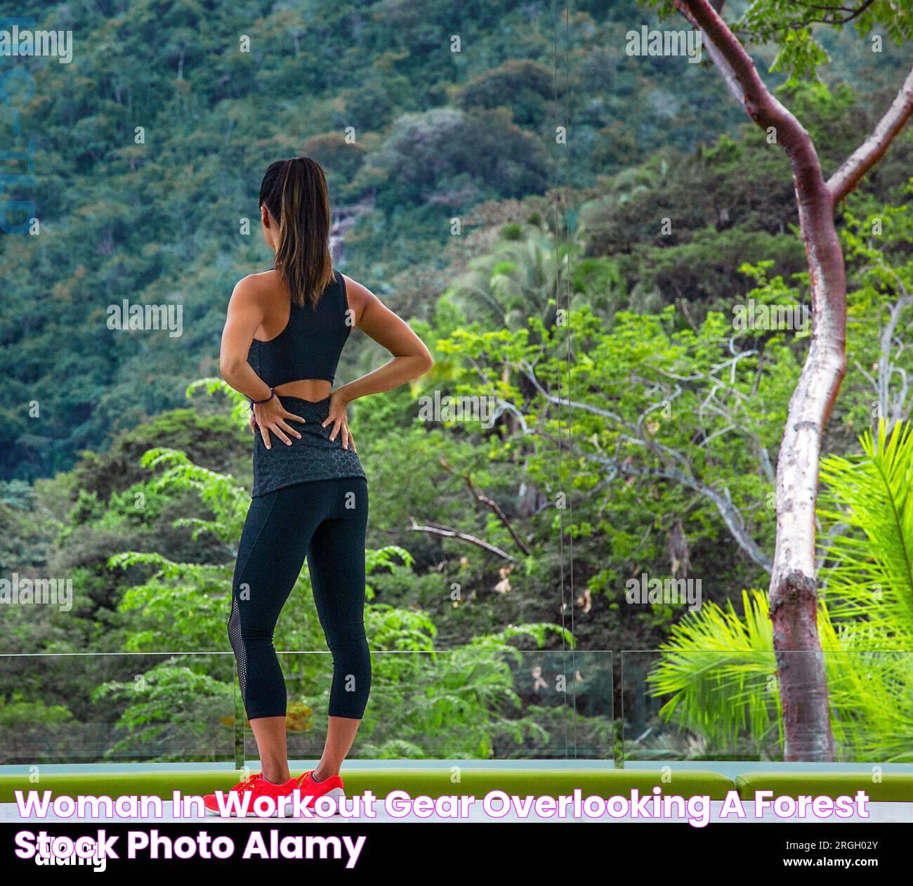 Woman in workout gear overlooking a forest Stock Photo Alamy